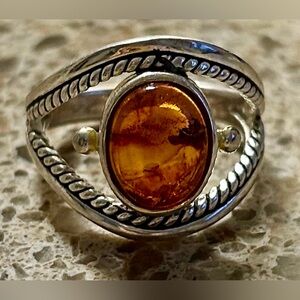 This is a vintage sterling silver .925 ring with an oval amber stone. Size 7
